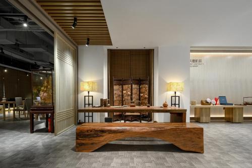 a room with a wooden table and chairs in it at Shenzhen ALLIN Space to time in Shenzhen
