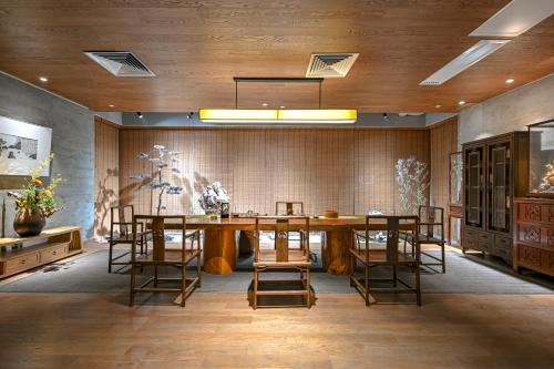a dining room with a large wooden table and chairs at Shenzhen ALLIN Space to time in Shenzhen