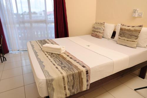 Katil atau katil-katil dalam bilik di Merry Villa Hotel & Apartments