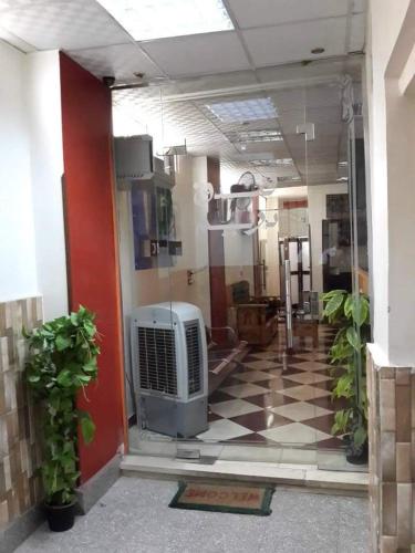 a room with a room with a radiator on a checkered floor at Dream Hotel in Qena