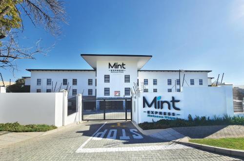 a white building with a sign on the front of it at MINT Express Melrose View in Johannesburg