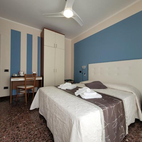 a bedroom with a bed and a desk with a chair at Hotel Bellavista Meublè in Monte Isola