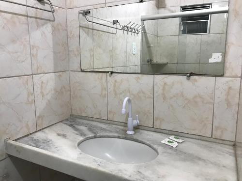 a bathroom with a sink and a mirror at Pousada Alto Astral in Olinda