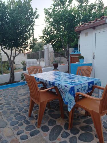 a table and chairs sitting on a patio at Island house in Elika - Marathias in Elíka