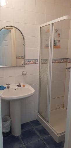 a bathroom with a sink and a shower at Beautiful 3 Bed Apartment with Balcony Sea View in Dunfanaghy