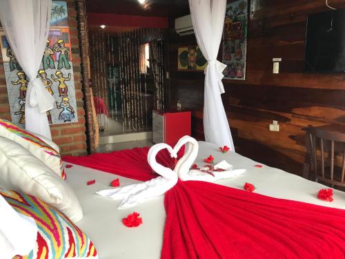 a bed with a heart made out of white ribbon at Pousada Alto Astral in Olinda