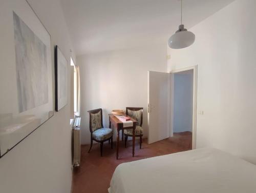 a bedroom with a bed and a table and chairs at Casa a Serrazzano in Serrazzano