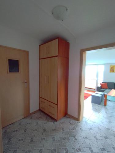 a room with a cabinet and a living room at Koralowa Ścieżka in Jelenia Góra-Jagniątków