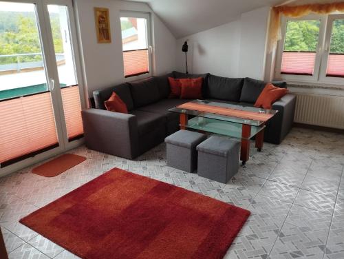 a living room with a couch and a table at Koralowa Ścieżka in Jelenia Góra-Jagniątków