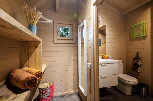 a small bathroom with a toilet and a sink at Mwezi Boutique Resort in Jambiani