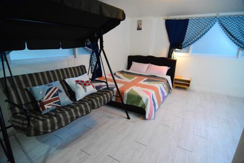 a bedroom with a bed and a couch at Residence Unicorn in Seoul