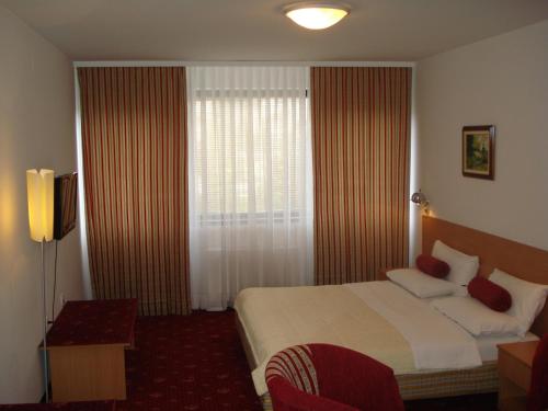 a hotel room with a bed and a window at Hotel Grand in Sarajevo
