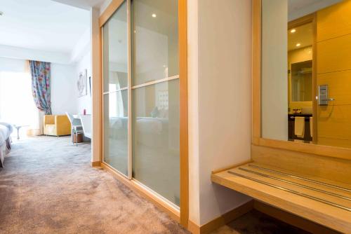 a room with a glass partition with a room with a bedroom at Hotel Farah Tanger in Tangier