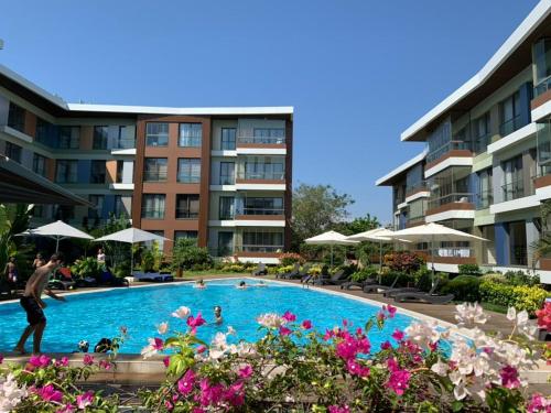 a man standing in a swimming pool in front of a building at WOW Property Accra the pearl in city in Accra