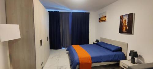 a bedroom with a bed with blue and orange at Blu-M Central in Qormi
