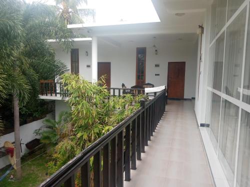 a corridor of a building with a balcony with plants at Green Ocean Bay in Arugam Bay