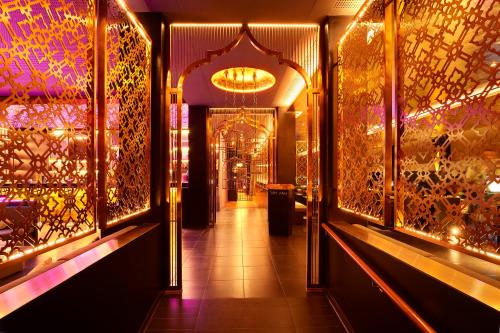 a hallway of a store with lights and mirrors at Panorama Resort & Spa in Feusisberg