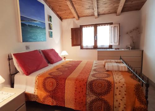 a bedroom with a large bed in a room at SA MENDUA E SA PRUNA casa al mare in Iglesias