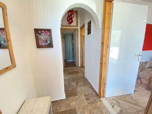 a hallway in a house with an archway at The Beachhouse Apartments in Vaia
