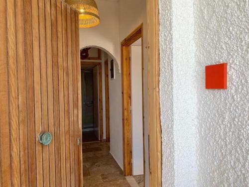 a hallway of a house with a door and a light at The Beachhouse Apartments in Vaia