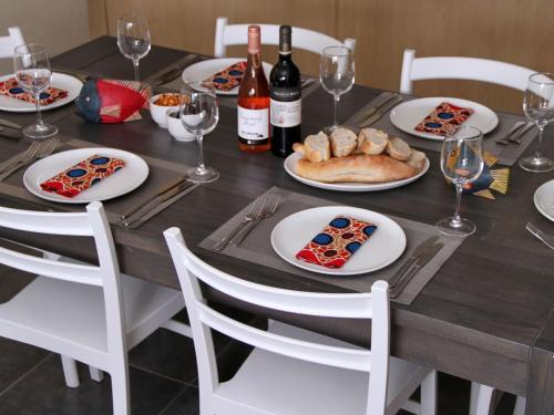 a wooden table with plates of food and wine bottles at Bilene Lodge by Dream Resorts in Vila Praia Do Bilene