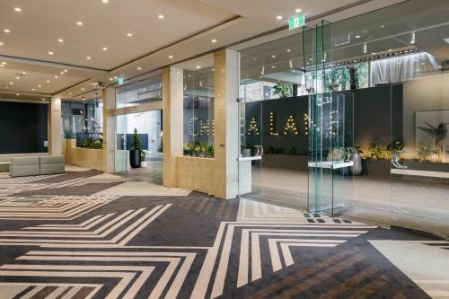a lobby of a building with a geometric carpet at voco Brisbane City Centre by IHG in Brisbane