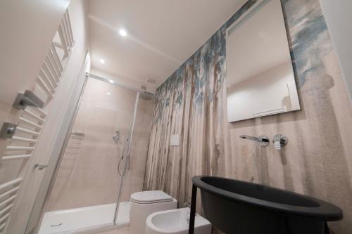 a bathroom with a shower and a sink and a toilet at Palazzo Franceschini in Cascia