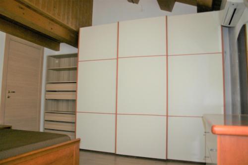 a large white cabinet in a room at A casa di Giò in Loreto
