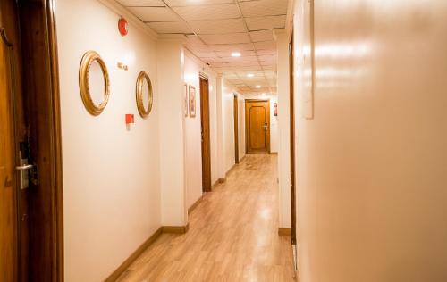 a hallway in an office building with a mirror on the wall at San Giovanni Stanly Hotel in Alexandria