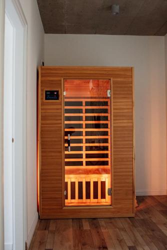 a wooden door in a room with wooden floors at Style Inn Apartmanok in Veszprém