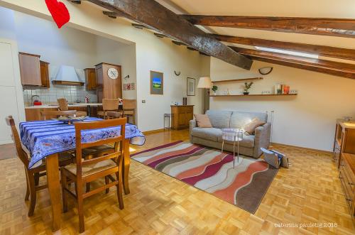 a living room with a table and a couch at Vecchie Tre Colonne in Cividale del Friuli