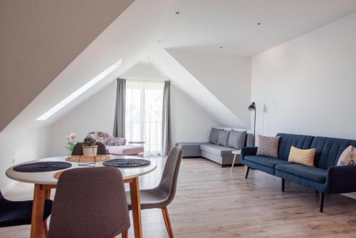 a living room with a table and chairs at Style Inn Apartmanok in Veszprém