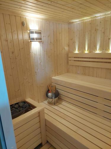 a wooden sauna with two benches and a fan at New Wolf in Bran