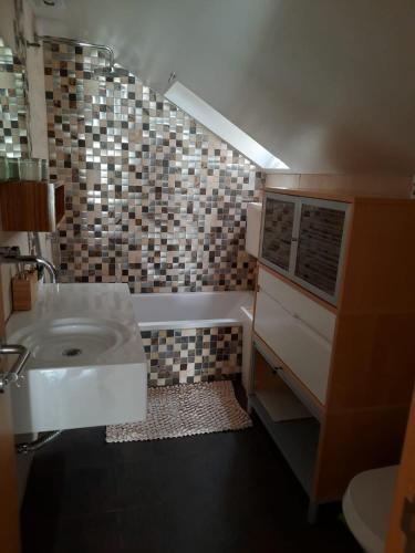 a bathroom with a sink and a toilet and a tub at Bemar Loft in Costa da Caparica