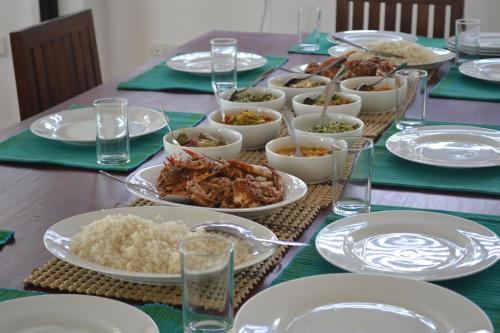 a table with plates of food and rice on it at Wellé Wadiya Beach Villa in Kalpitiya