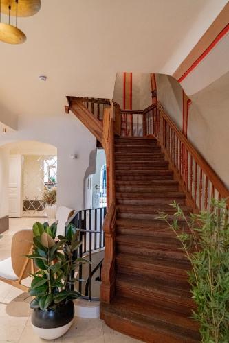 a wooden spiral staircase in a living room at Dome Hotel in Rīga