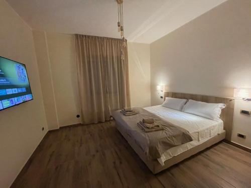 a bedroom with a bed and a flat screen tv at JSK Suite in Rome