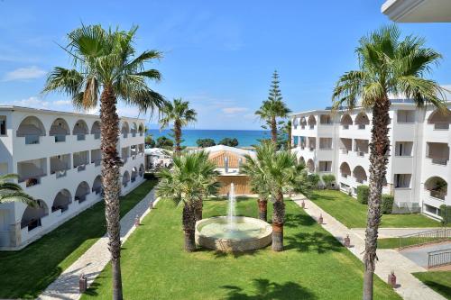 an aerial view of a building with a fountain and palm trees at Alykanas Beach Grand Hotel by Zante Plaza in Alikanas