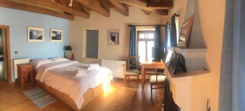 a bedroom with a bed and a television in it at Saxonis Houses & Saxonis Villa in Papigko
