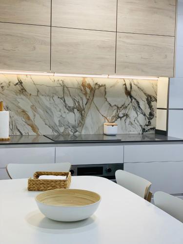 a kitchen with a white table with a bowl on it at Apartamento Pereiro Viveiro in Viveiro