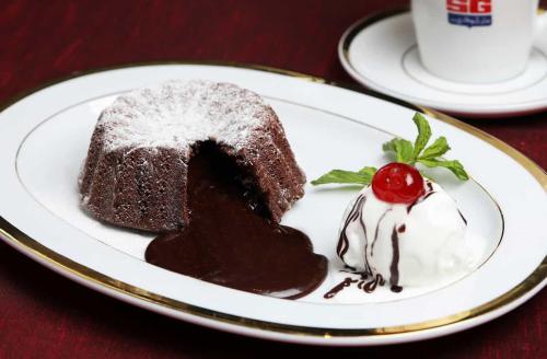 a piece of chocolate cake on a plate on a table at San Giovanni Stanly Hotel in Alexandria