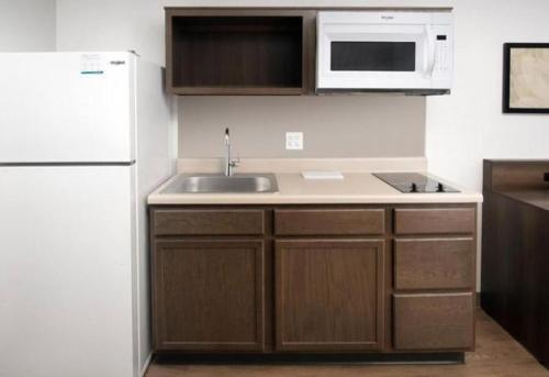 eine Küche mit einer Spüle und einem weißen Kühlschrank in der Unterkunft WoodSpring Suites Littleton-South Denver in Littleton