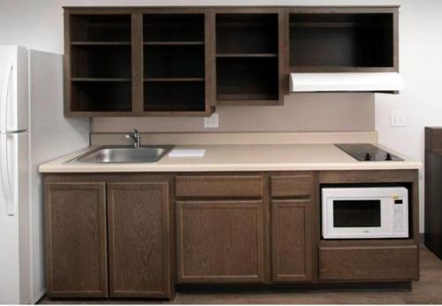 a kitchen with a sink and a microwave at WoodSpring Suites Littleton-South Denver in Littleton