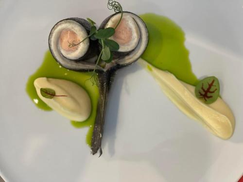 a plate of food with mushrooms on a green leaf at Filotera Suites in Oia