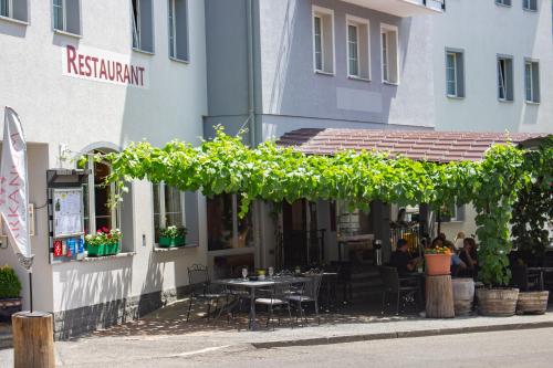 a restaurant with a table in front of a building at Hotel Arkanum in Salgesch