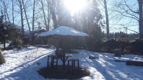 a gazebo in the snow with the sun shining at POSADA MI ESPERANZA in Cacheuta