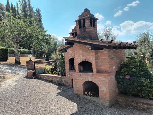an outdoor brick oven in a garden at Poggio Massiccioli in Poggibonsi