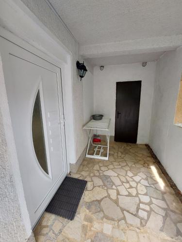 a hallway with a door and a table in a room at Apartment Rupena in Klimno