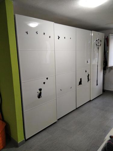 a room with white lockers with black cats on them at Costa dei trabocchi 2 in San Vito Chietino