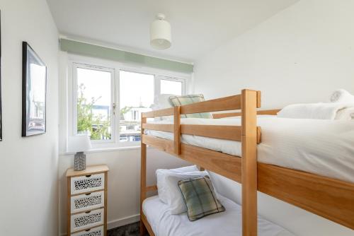 a bedroom with two bunk beds and a window at The Loft on the Lane - 2 Beds - Garden - 5 mins to harbour in Crail